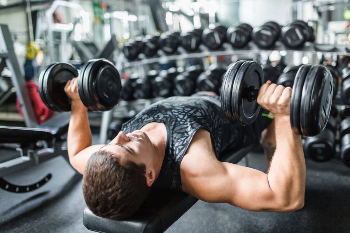 Man performing dumbbell bench press