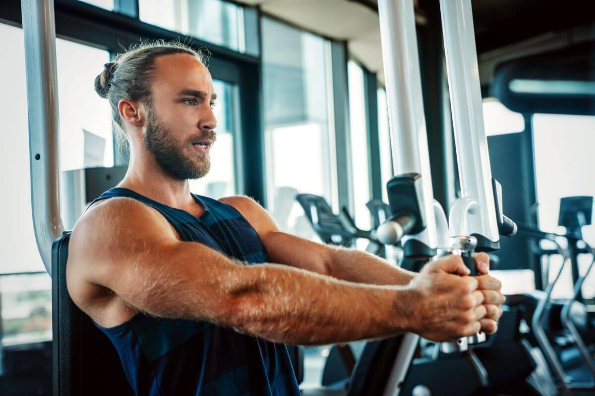 Man performing Machine Chest Fly exercise