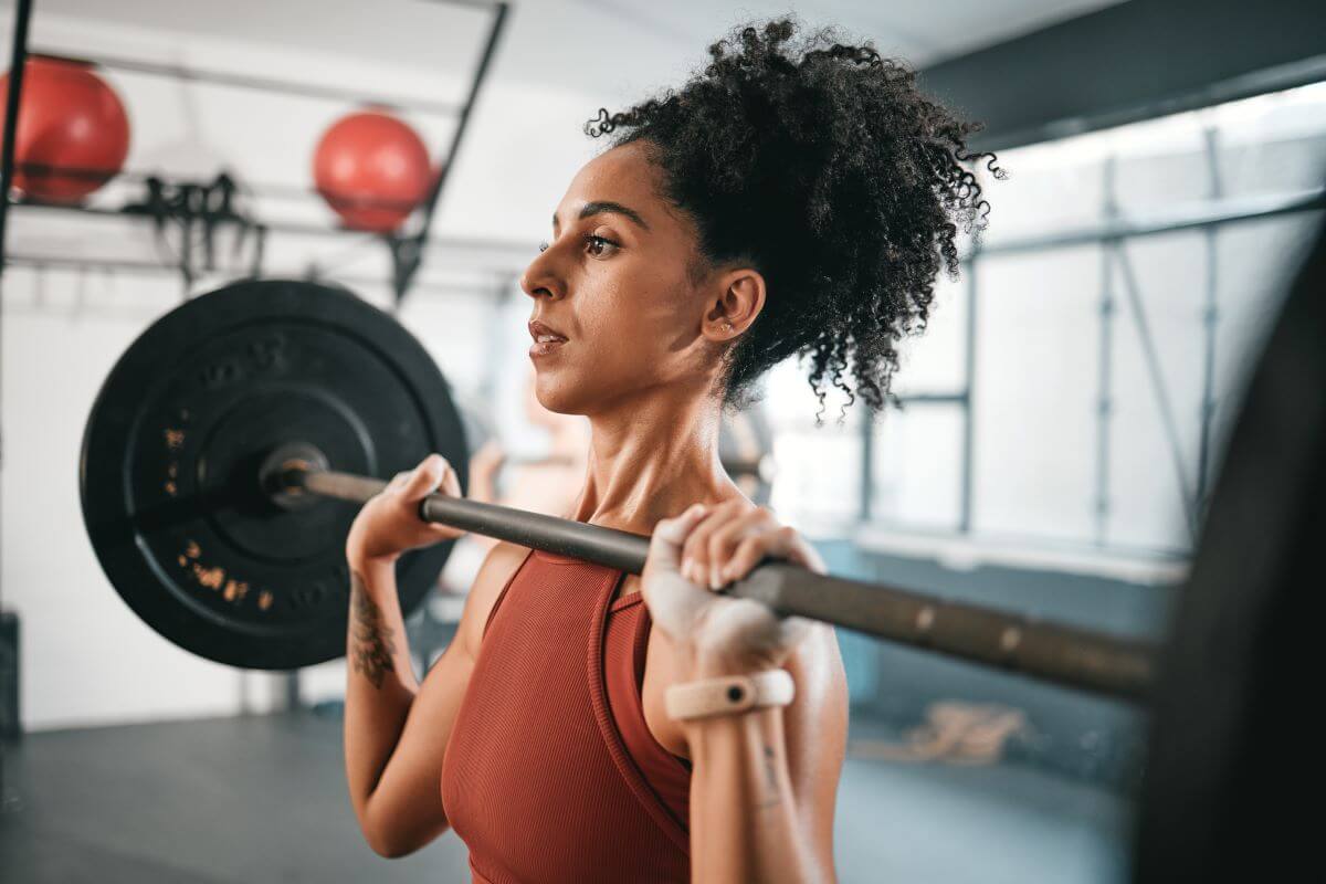 Strong woman performing Barbell Shoulder Press