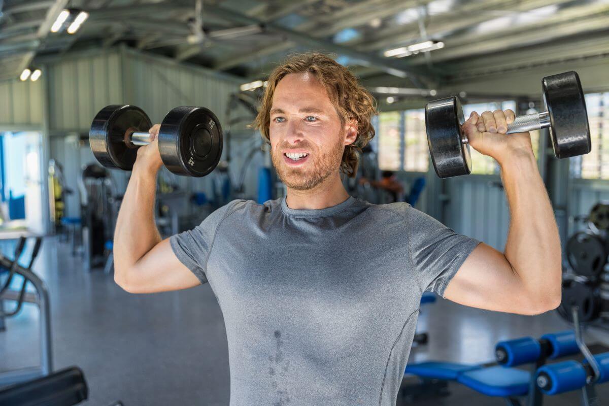 Man Performing Dumbbell Shoulder Press during workout