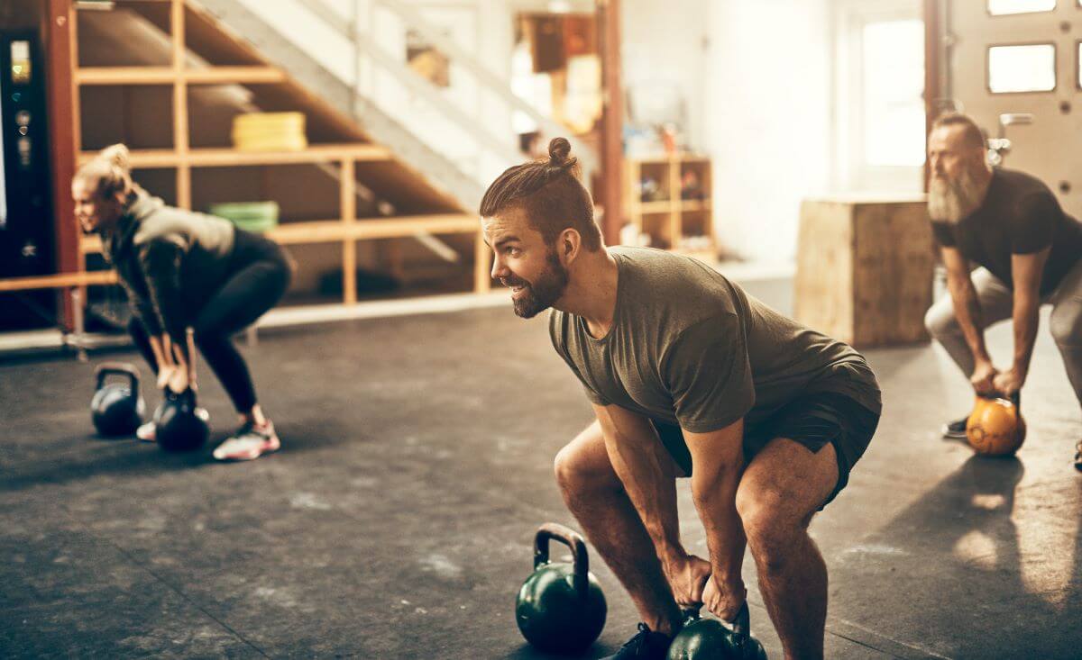 Group of fit people performing supersets as part of their intense workout routine