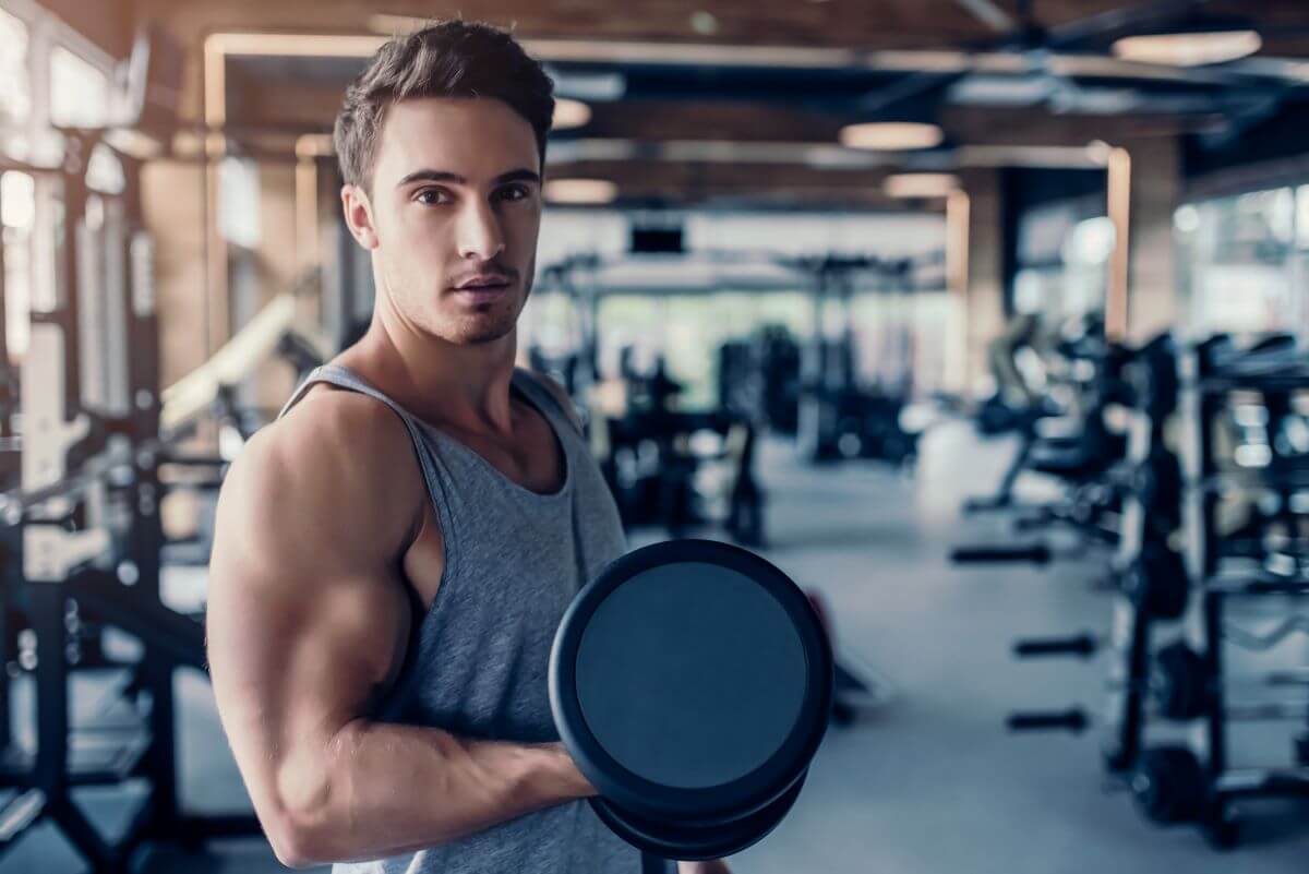 Man performing a 4 day upper lower dumbbell workout routine