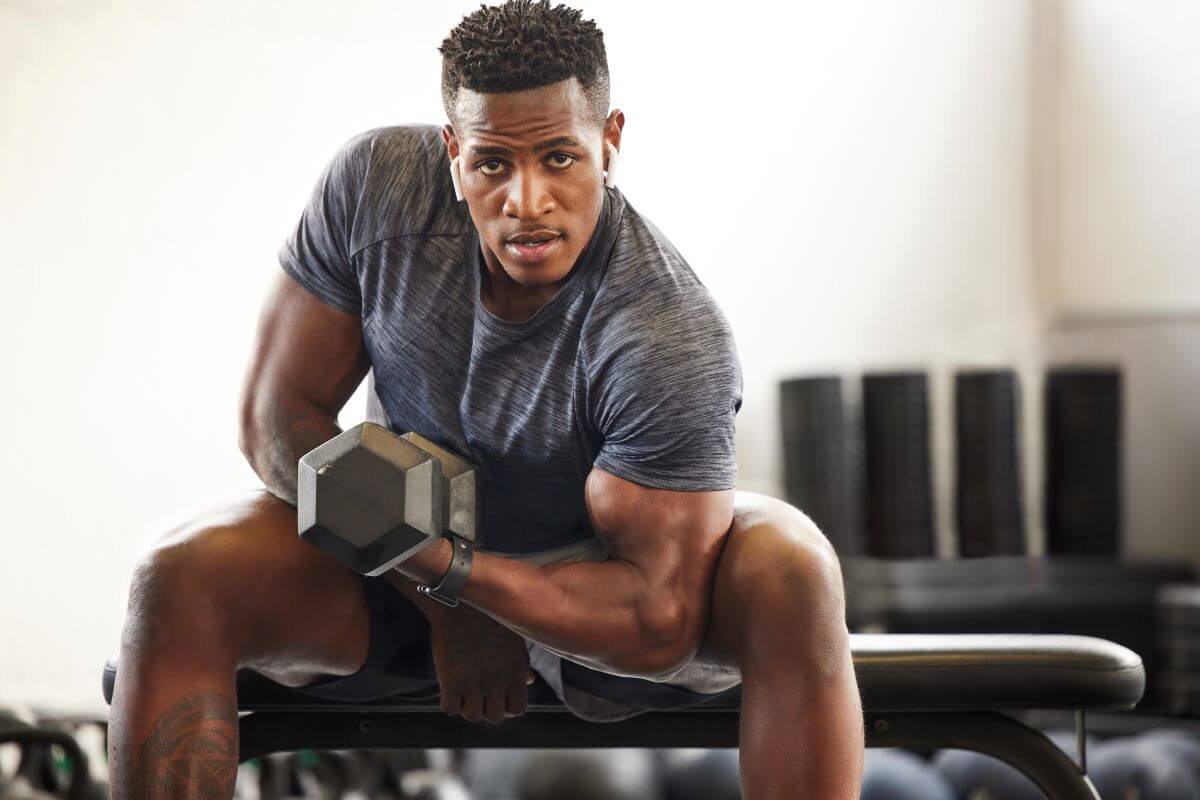 Man performing curls as part of 4 day bro split workout