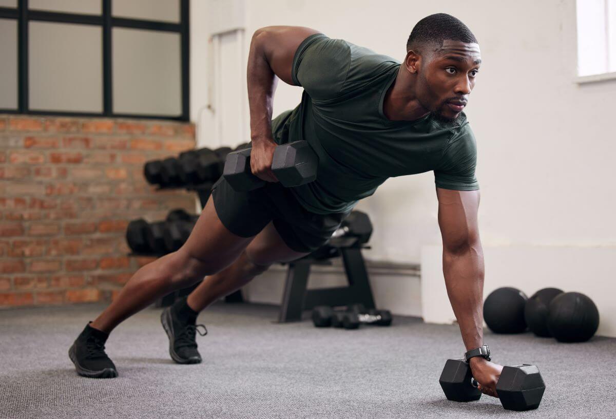 Man performing dumbbell exercise during 4 day dumbbell full body workout routine