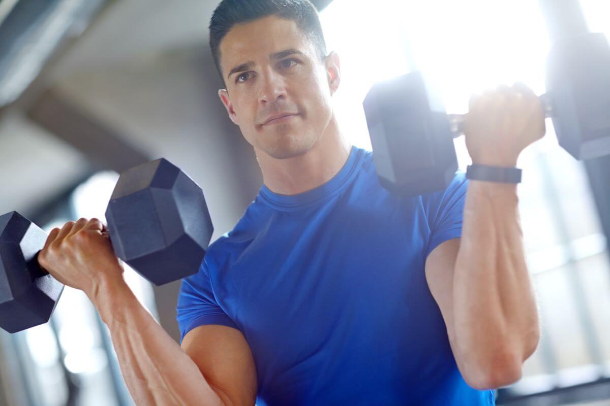 Man performing bicep curls during his 4 day full body workout routine