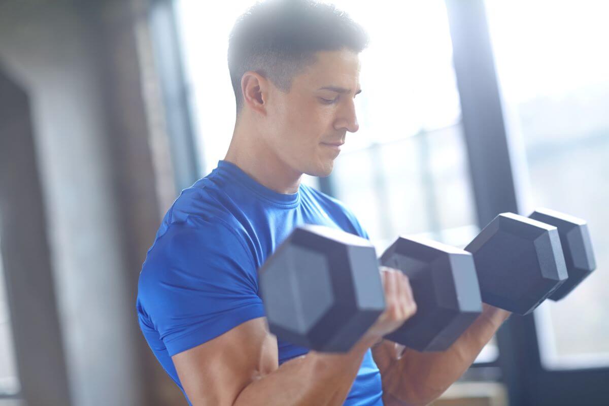 Man performing a 4 day dumbbell push pull workout