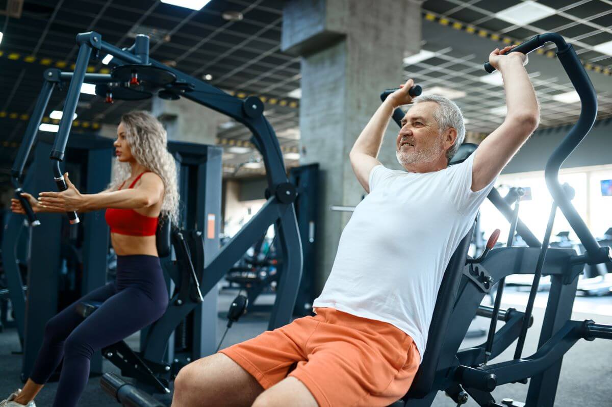 Man and woman performing machine exercises as part of a machine only planet fitness workout routine