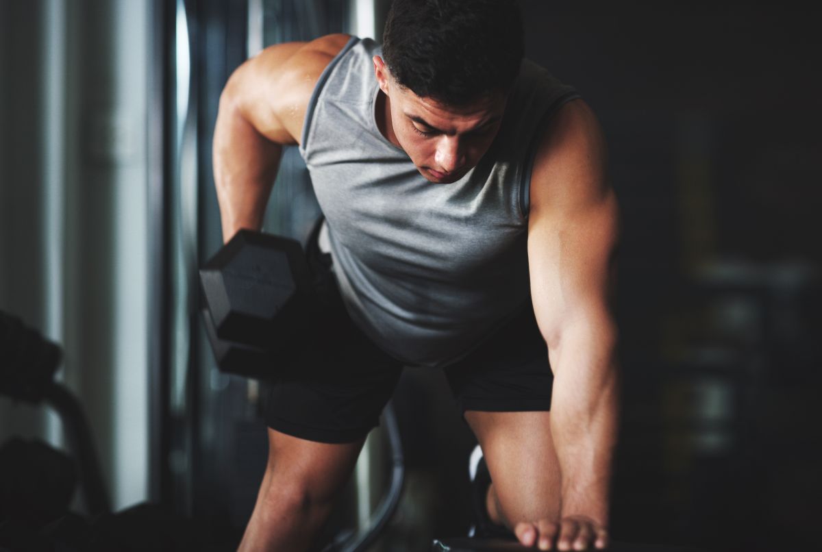 Man performing a back and bicep dumbbell workout